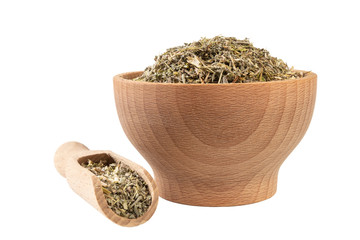 wormwood herb or in latin Absinthii herba herb in wooden bowl and scoop isolated on white...