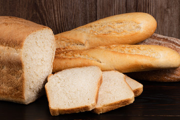 baked bread and baguette on wooden table background
