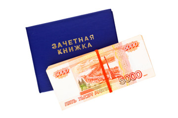 Student's exam book and stack of russian rubles isolated on white. Inscription on book in Russian: "Examination book"