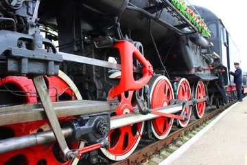 Steam locomotive and train driver. Antique train.