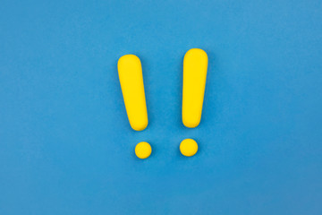 Two vivid exclamation marks on blue background. Flat lay, warning, keep attention concept.