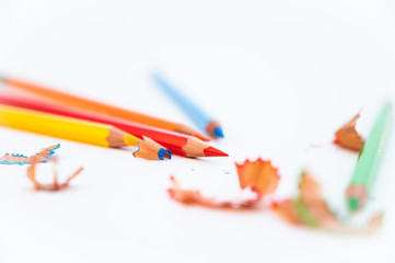 Colorful pencils with sharpening shavings, on white background. Color pencils isolated on white...