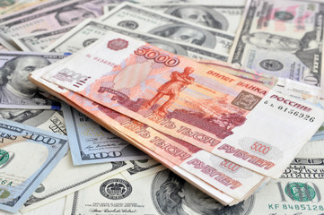 Fototapeta na wymiar Russian 5000 rubles and 100 dollars close-up, the concept is laid out as a background. Out of focus, blur