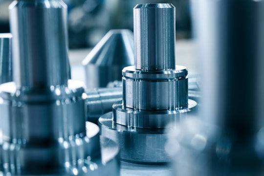 Iron parts machined on a CNC lathe close-up. Metalworking parts in the manufacture of CNC machine tools.