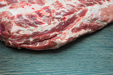 Fresh raw pork meat on the wooden table. Raw juicy meat steak on dark wooden background