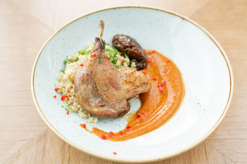 Plate Duck leg su-vide, with bulgur and onion marmalade. Barbecue restaurant menu, a series of photos of different meats