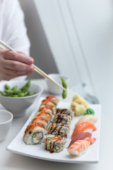 Sushi Roll Set with Seafood on White Plate. Lunch in Japanese Restaurant