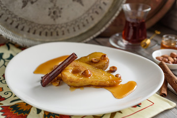 Cinnamon Poached Pears with Caramel Sauce and Hazelnuts