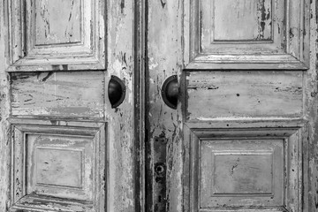 Vintage old wooden door with cracks background texture, peeling paint retro design black and white