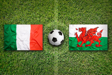 Italy vs. Wales flags on soccer field
