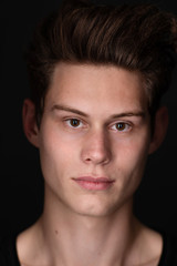 Obraz premium Portrait of a young handsome dark haired man with a fan