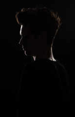 Portrait of a young handsome dark haired man with a fan