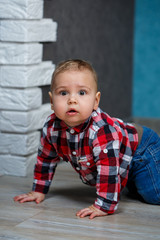 Fototapeta premium little boy ten months old in a shirt and jeans