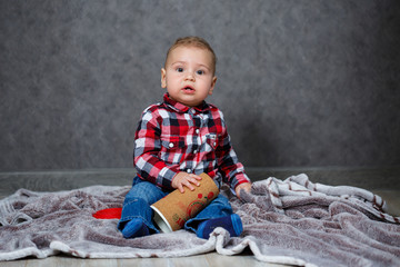 little boy ten months old in a shirt and jeans