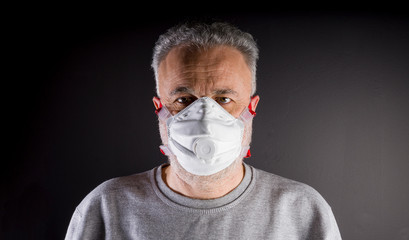 Coronavirus concept. Man with mask to protect himself from Covid-19 infection. Respiratory protection. 