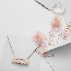 The wedding background with space for text, decorated with invitation envelopes and decorations for the bride, is made in soft pastel colors, with copy space. Conceptual backgrounds for wedding texts.