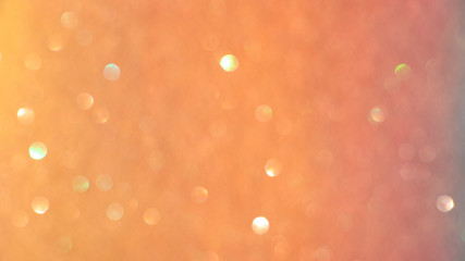 Soft focus, light bokeh on orange background.