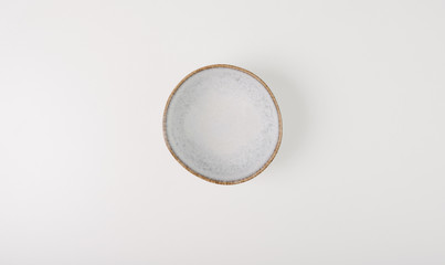 Empty small ceramic round plate isolated on white background