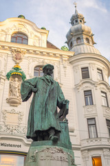 Fototapeta na wymiar Johannes Gutenberg monument and the insurance company Wustenrot building in background