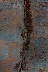 Peeling colored paint on old rusty metal. Abstract corrosion texture