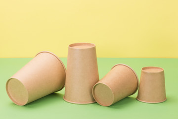 Paper cups in the green and yellow background.