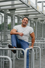 Fototapeta na wymiar A sports guy stands and enjoys a walk near the stadium. Lifestyle