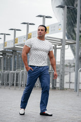 A sports guy stands and enjoys a walk near the stadium. Lifestyle