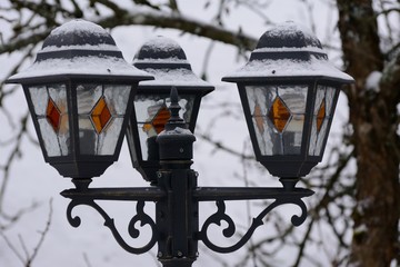 Snow covered old street lamp