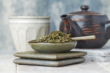 Dried Green Tea Leaves on Bright Background.