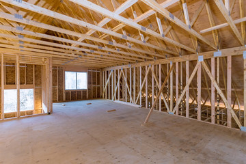 Interior of attic room with under reconstruction installing wooden frame for improvement