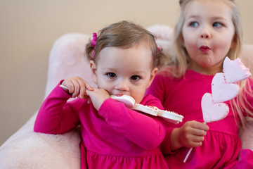 Closeup of two little girls enjoying a sweet treat