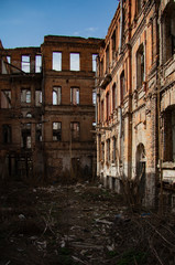 Fototapeta premium The ruins of an old brick abandoned house look like after the bombing