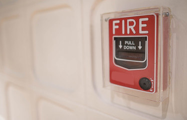 The red fire alarm switch on the wall at the Bangkok subway.