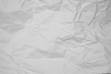 white and gray wide crumpled paper texture background. crush paper so that it becomes creased and wrinkled.