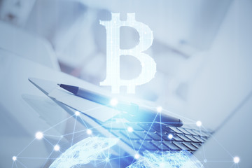 Multi exposure of blockchain and crypto economy theme hologram and table with computer background. Concept of bitcoin cryptocurrency.