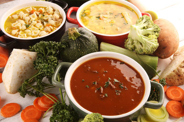 Set of soups from worldwide cuisines, healthy food. Broth with noodles, beef soup and broth with marrow dumplings. All soups with healthy vegetables on table