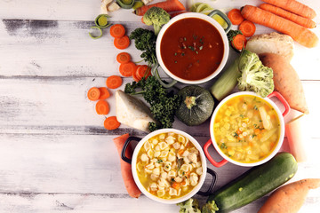 Set of soups from worldwide cuisines, healthy food. Broth with noodles, beef soup and broth with marrow dumplings. All soups with healthy vegetables on table
