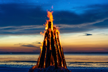 The big fire burns against the background of the night sky, close up