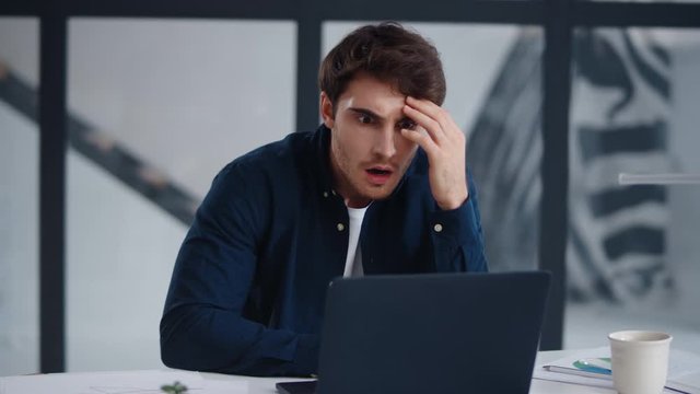 Closeup shocked business man looking computer screen in office