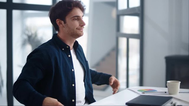 Happy business man finishing work on laptop indoor. Man meditating near computer