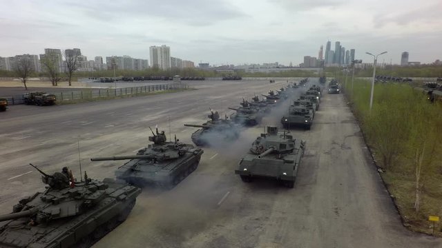 MOSCOW, RUSSIA - MAY 07, 2019: Aerial shot of trial run of military parade, column of tanks with soldiers setting off