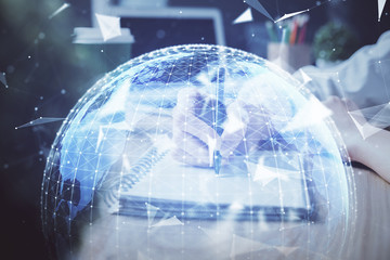 Naklejka premium International business hologram over woman's hands taking notes background. Concept of success. Double exposure