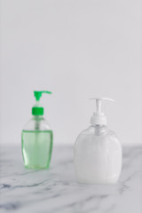 hygiene against viruses and bacteria, hand sanitizer and liquid soap bottle on marble bathroom