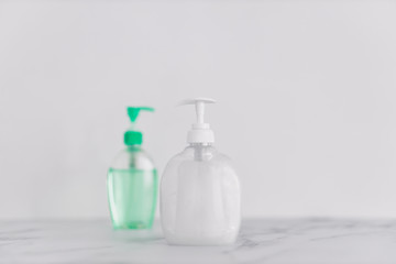 hygiene against viruses and bacteria, hand sanitizer and liquid soap bottle on marble bathroom