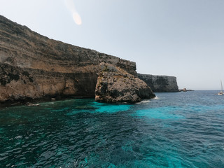 Rocks on the island of Malta, surrounding them a clear water. The island of Malta, Gozo and Comino...