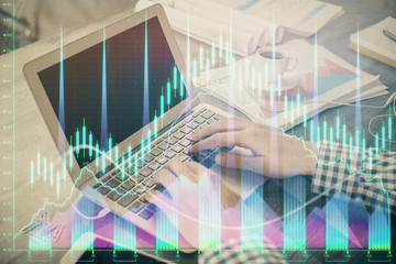 Double exposure of forex graph with man working on computer on background. Concept of market analysis.