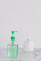 hygiene against viruses and bacteria, hand sanitizer and liquid soap bottle on marble bathroom