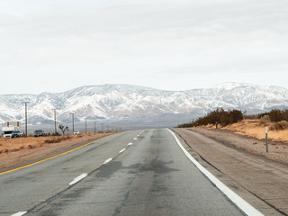 Mojave, United States - December 02, 2019: Car traffic by road in the Mojave Desert.