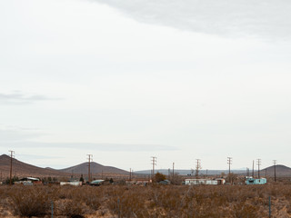 Fototapeta na wymiar Mojave, United States - December 02, 2019: Car traffic by road in the Mojave Desert.