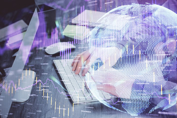 Stock graph with businessman typing on computer in office on background. Concept of analysis. Double exposure.